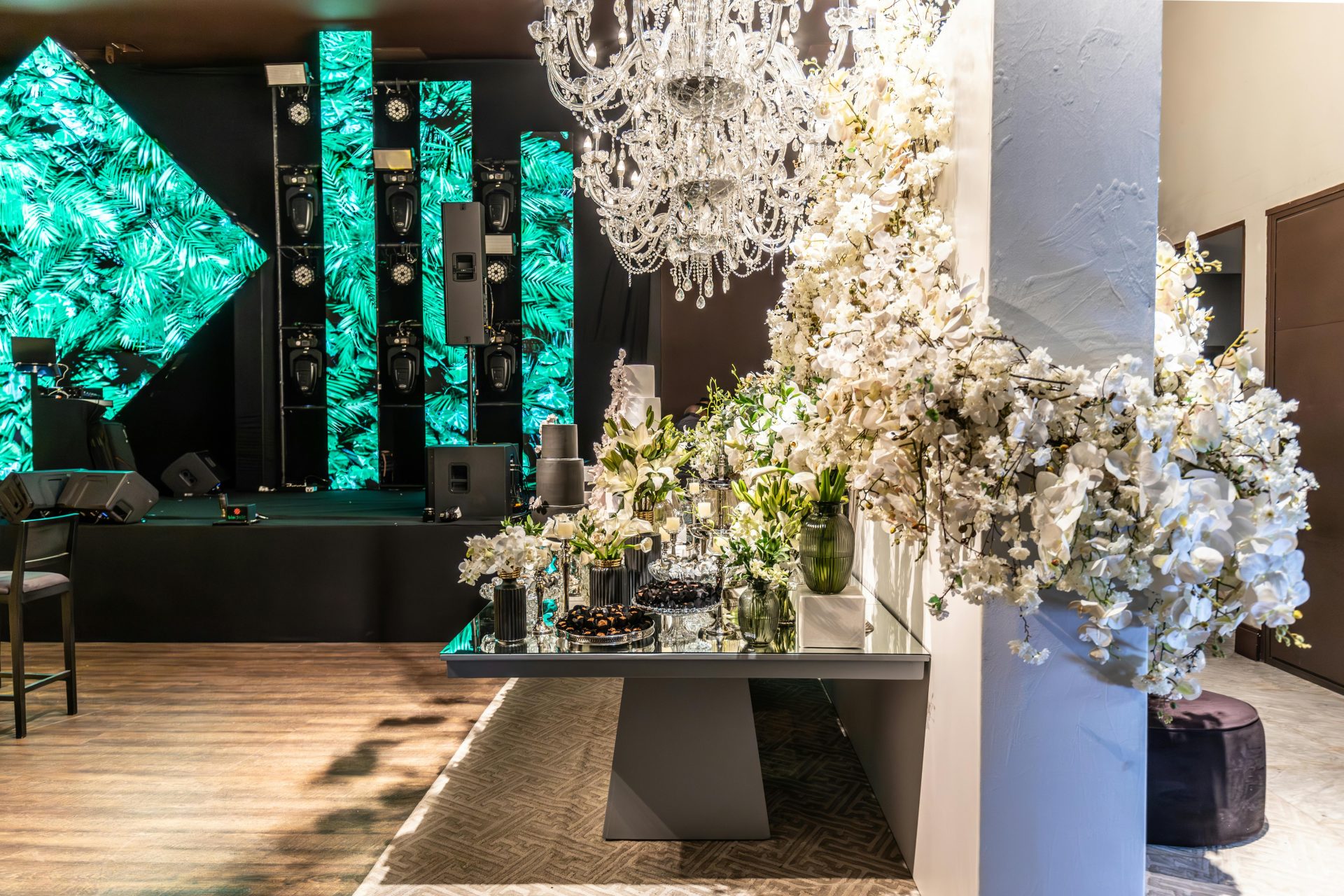 A luxurious banquet hall setup with elegant floral arrangements and a grand chandelier, perfect for events.